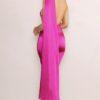 Brunette in hot pink maxi dress with open back looking over her shoulder.